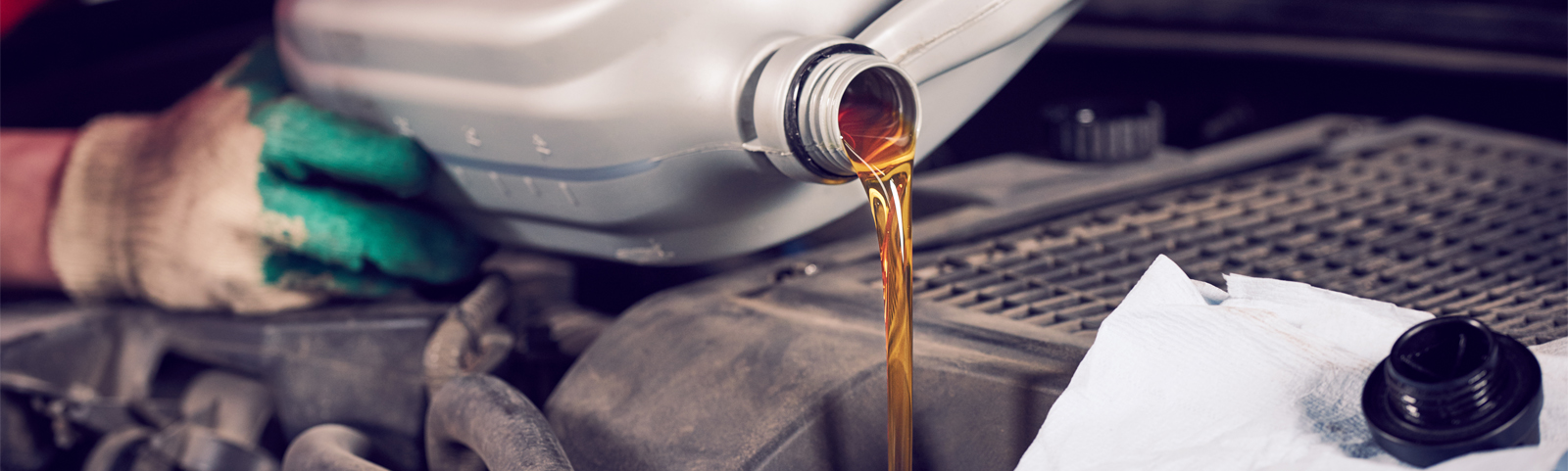 Mechanic pouring engine oil into a vehicle - Car Servicing Alton